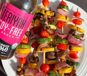 A colorful plate featuring an assortment of fresh vegetables arranged on skewers.