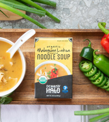 Ocean's Halo Malaysian Laksa Noodle Soup next to a bowl of soup and vegetables.